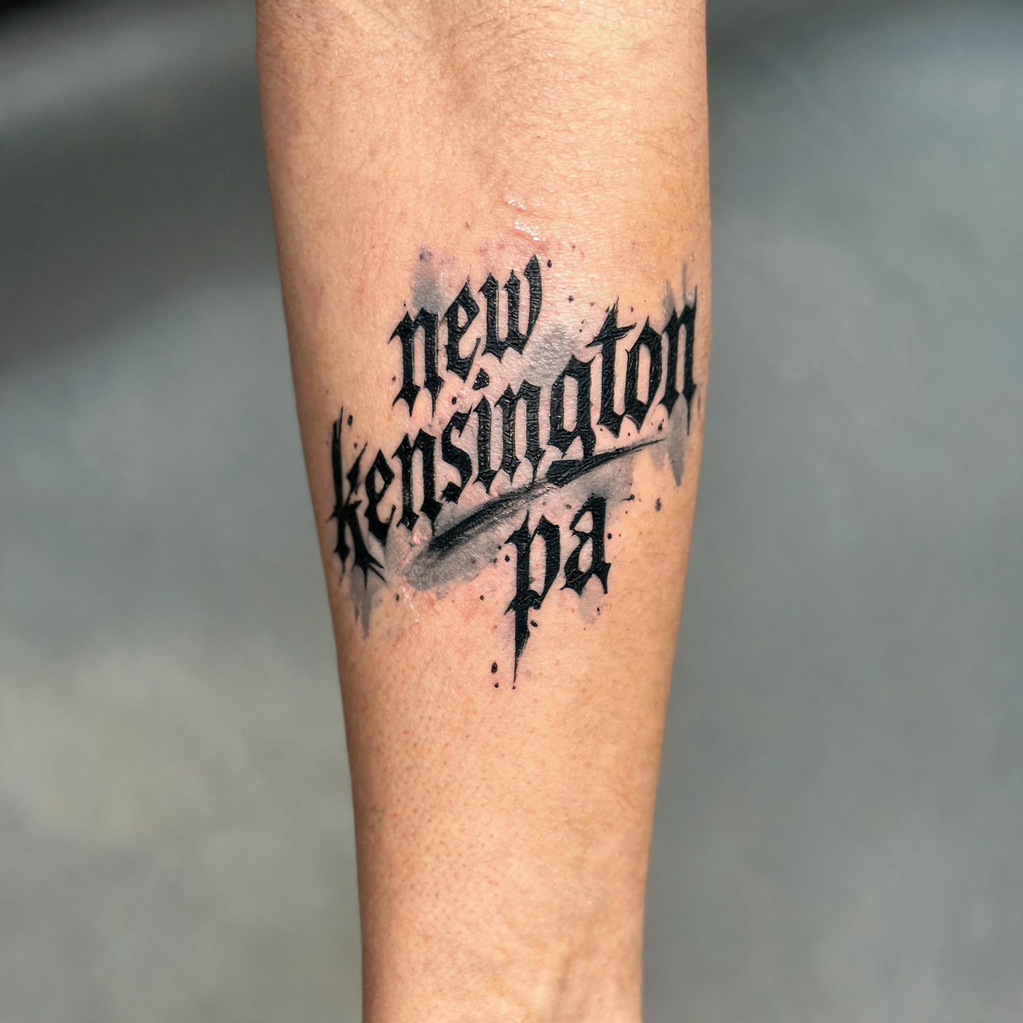 Trash polka tattoo of the true image tattoo new kensington pa on an outer forearm, shown in a photo on a white background.