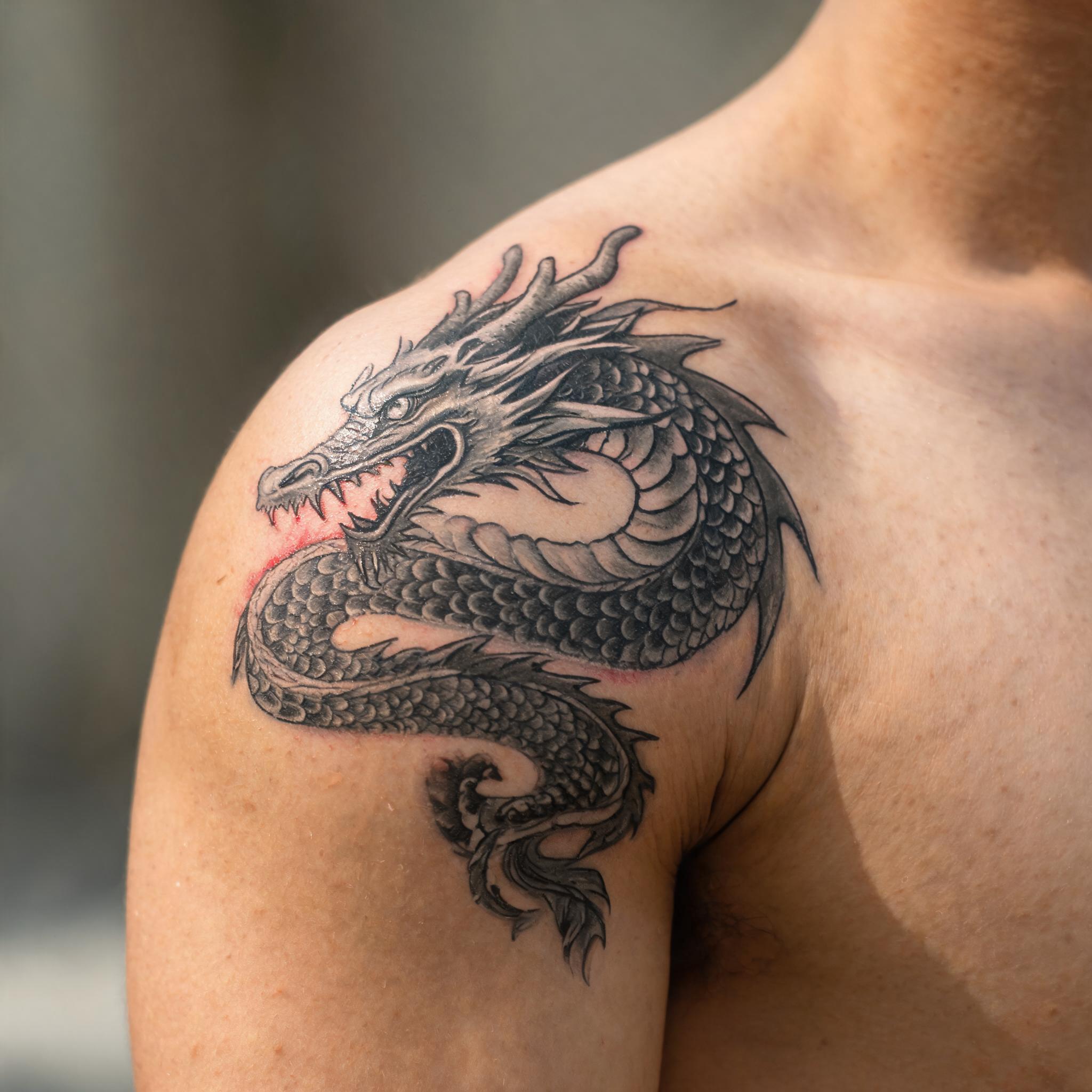 dragon tattoo images. Creative Freedom style, placed on the shoulder. Made with Tattloom.