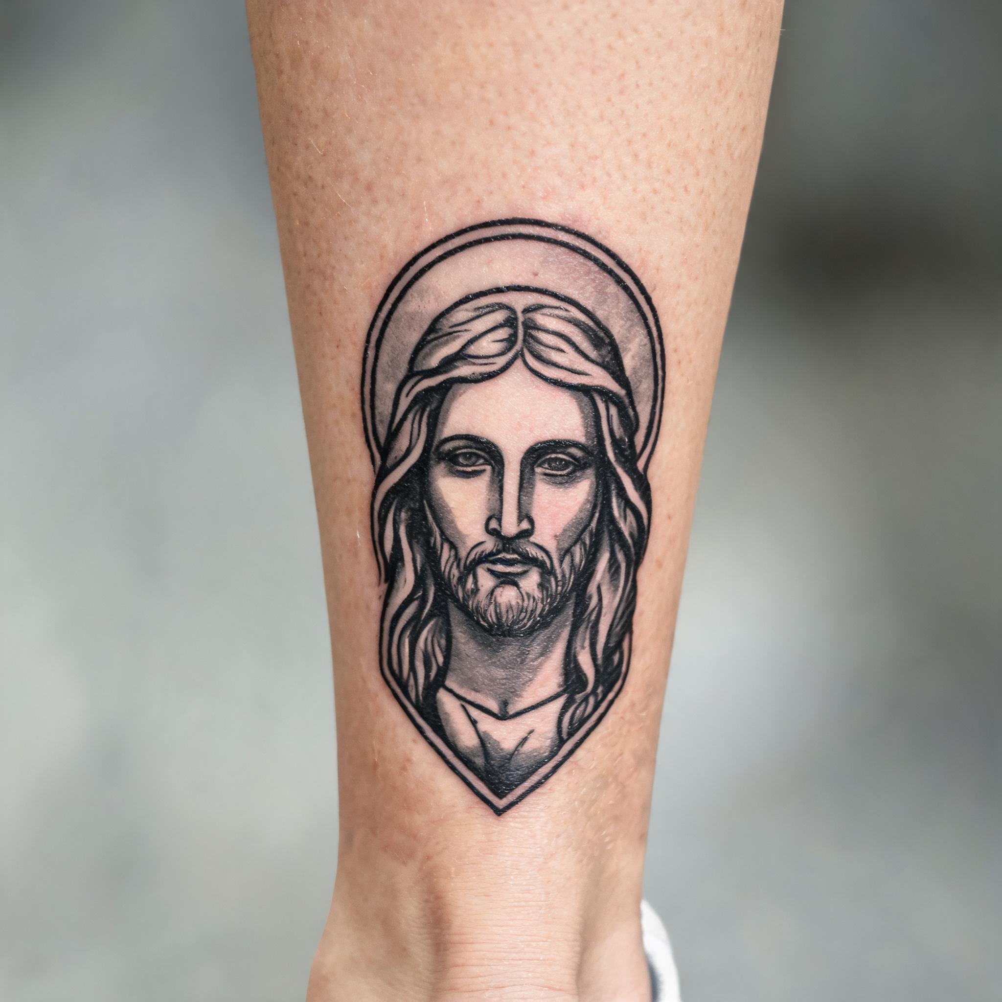 Imago Dei tattoo in American Traditional style on a shin, shown in black and grey on a white background as a tattoo image.
