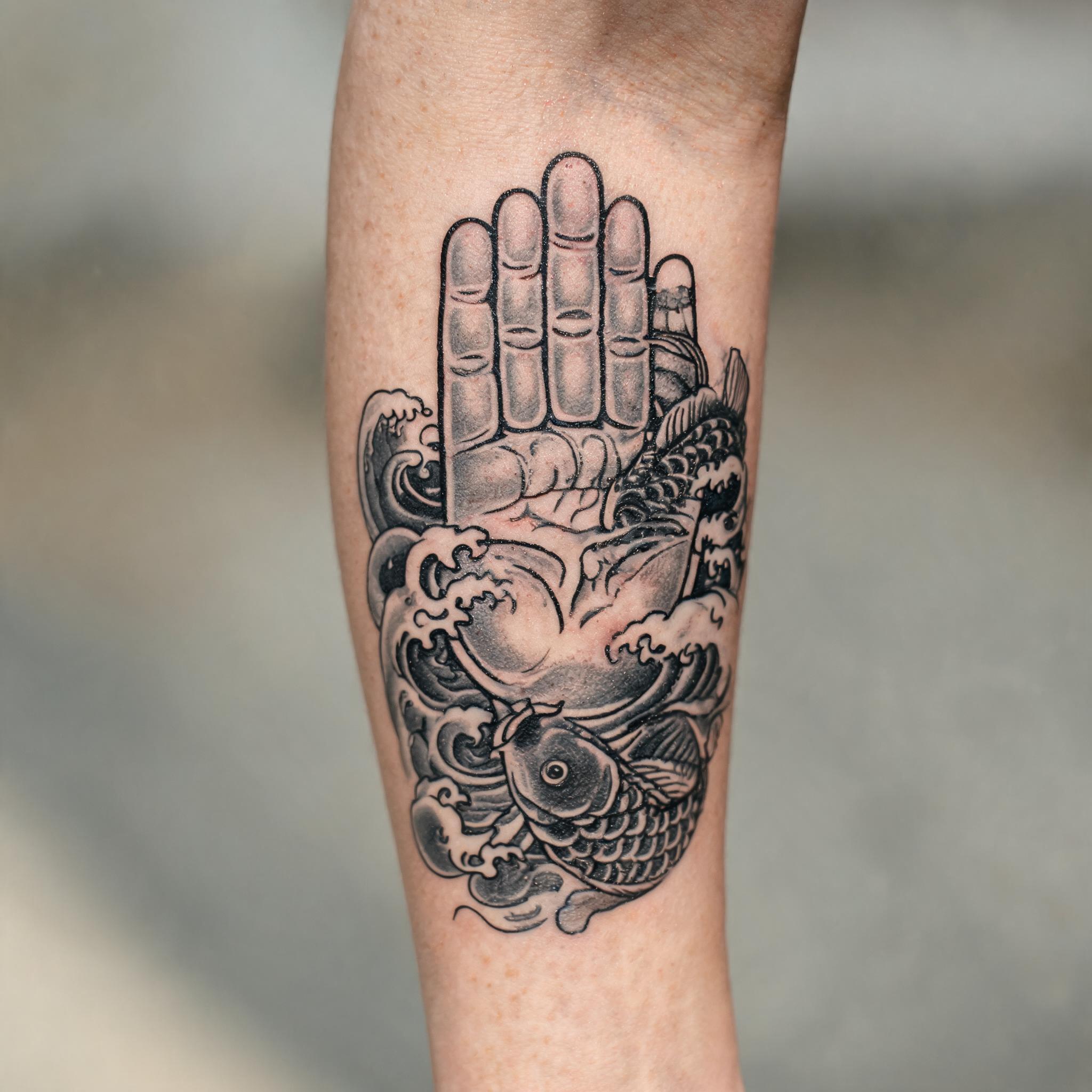 A hamsa hand tattoo design in Japanese irezumi style, shown on an inner forearm in black and grey ink as a tattoo image.
