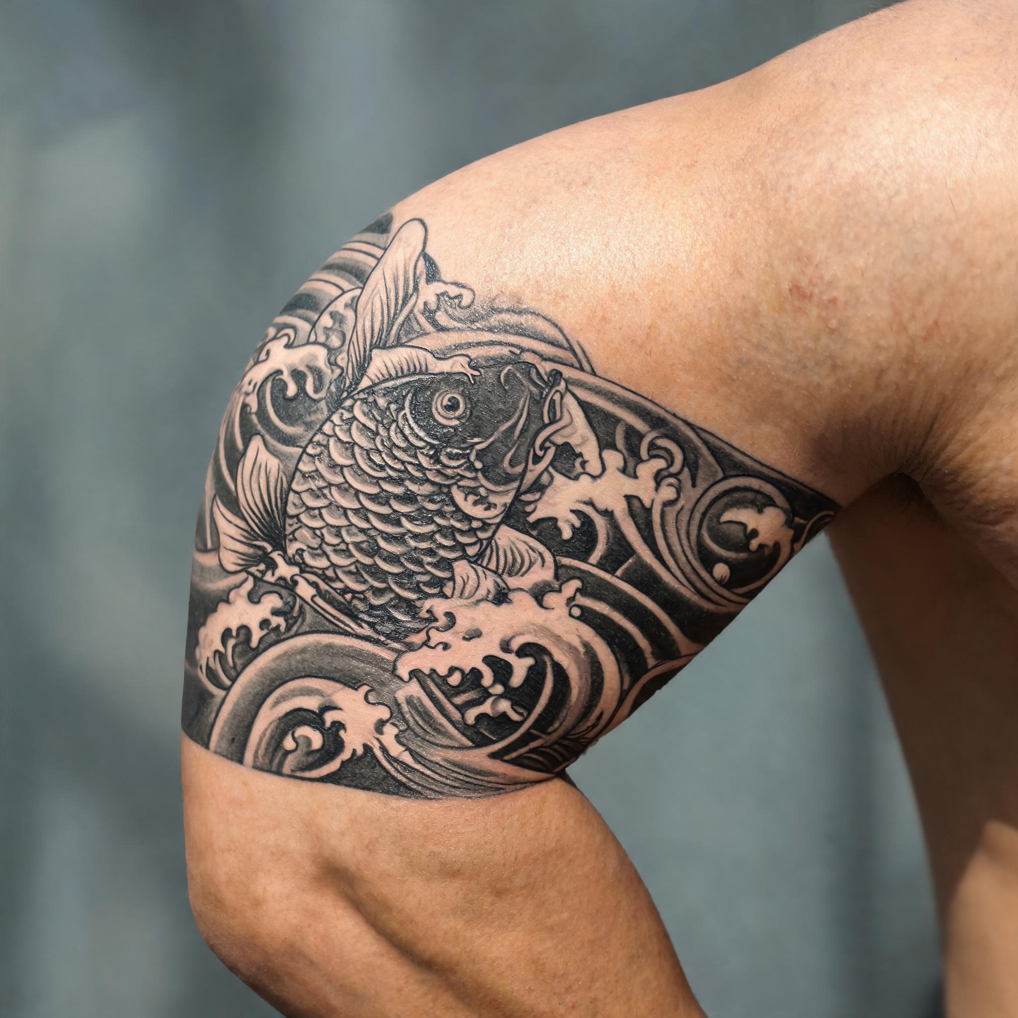 A celtic warrior tattoo design in Japanese irezumi style on the outer upper arm, shown in black and grey on a clean neutral background as a tattoo image.